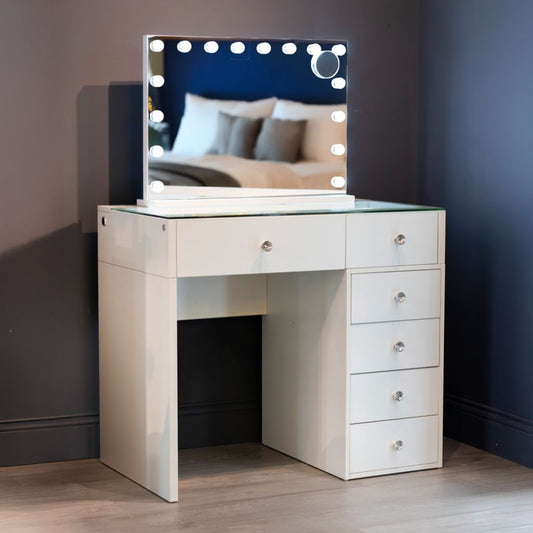 White vanity table with illuminated mirror set.