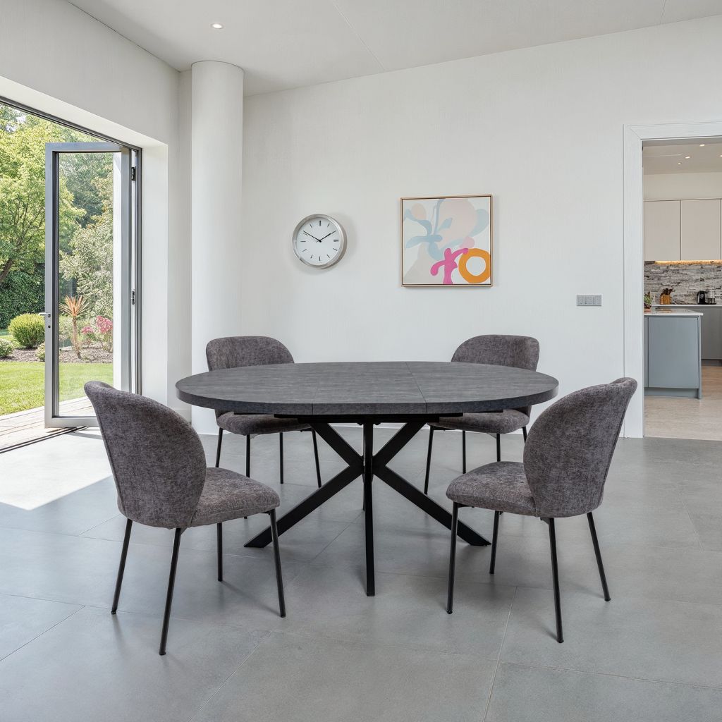 Dining area with a round table and four chairs in a modern home setting.