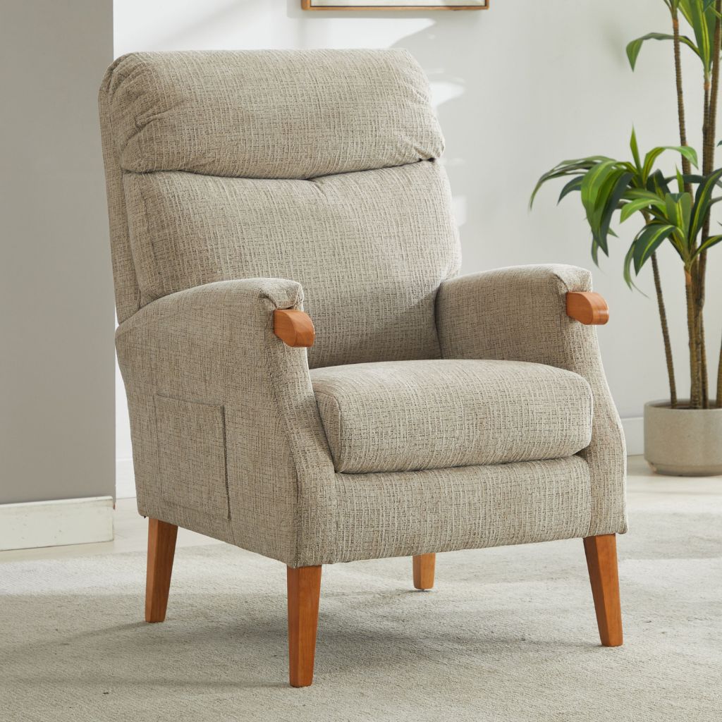 Beige armchair with wooden arms and legs in a room with a plant.
