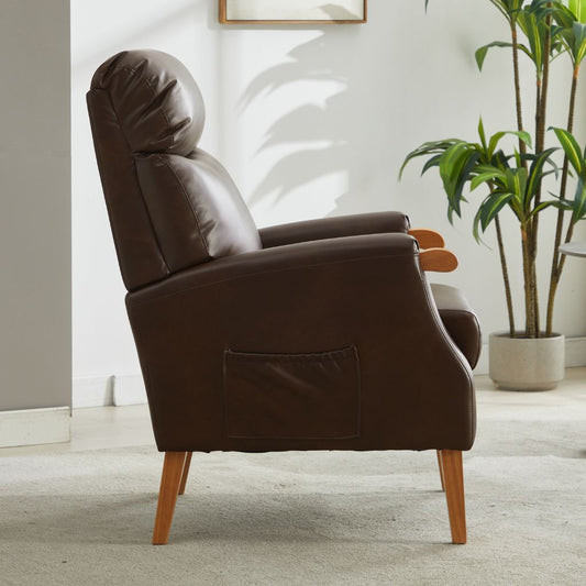 Brown pu armchair in a room with a plant and framed picture on the wall.
