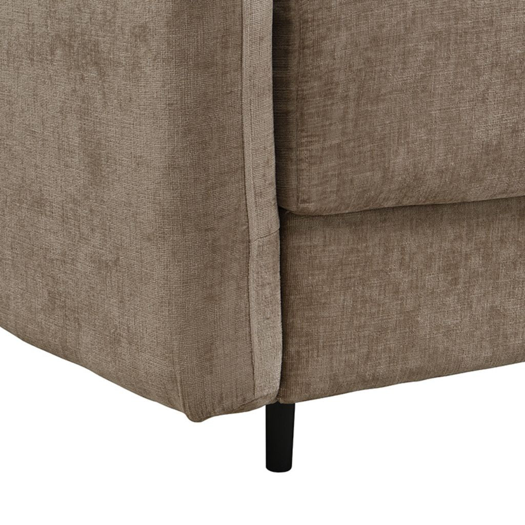 Close-up of a brown upholstered chair corner with a white background