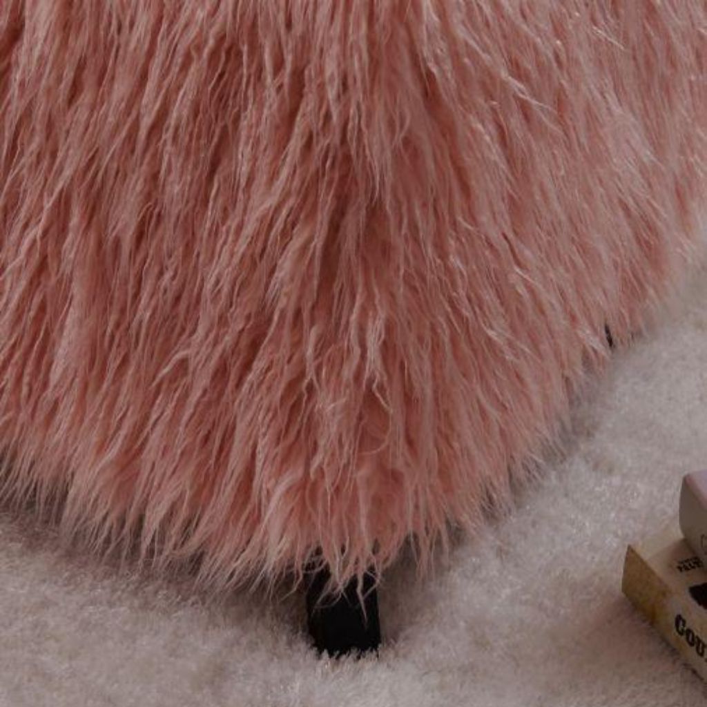 Close-up of a pink fluffy surface on a light-colored carpet