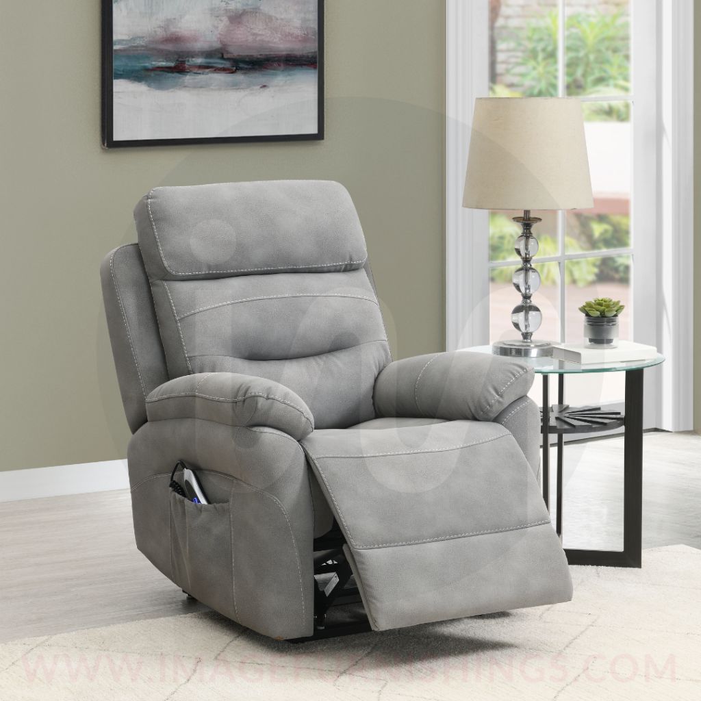 Gray recliner chair in a living room setting with a lamp and table in the background.