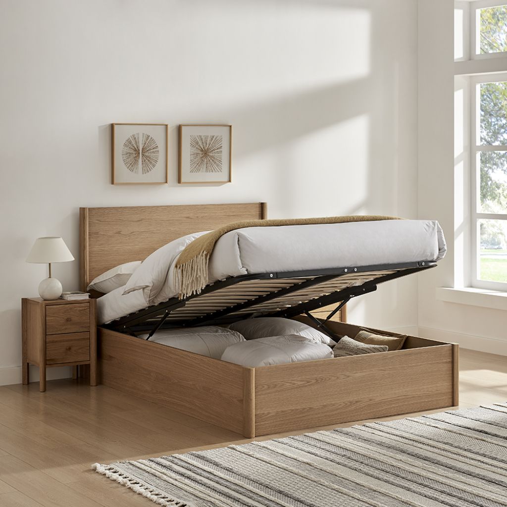 Wooden bed with storage compartments in a bright bedroom.