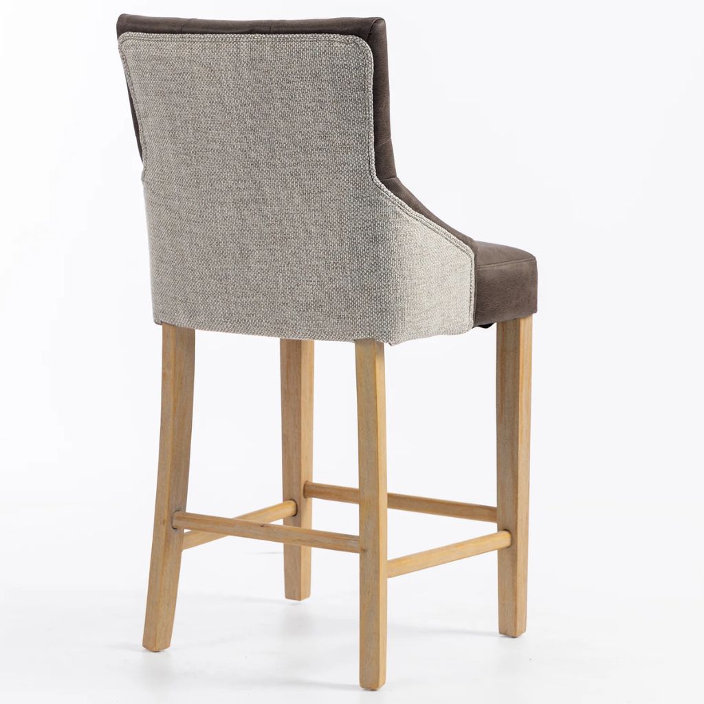 A modern barstool with a textured natural chenille fabric backrest, and light natural wood legs and footrest, shown from a three-quarters angle.
