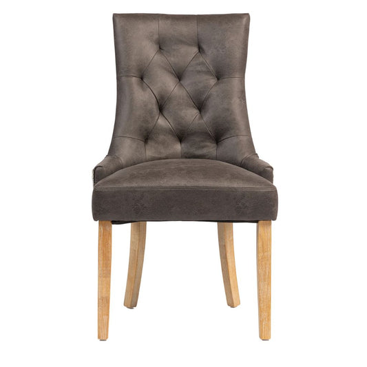 A single upholstered dining chair with a tall, winged back, diamond tufted button detailing, and light natural wood legs.