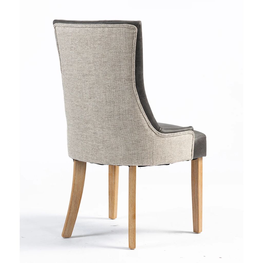 A high-back dining chair with a textured light beige fabric upholstered back and four tapered natural wood legs, shown from a three-quarter angle.