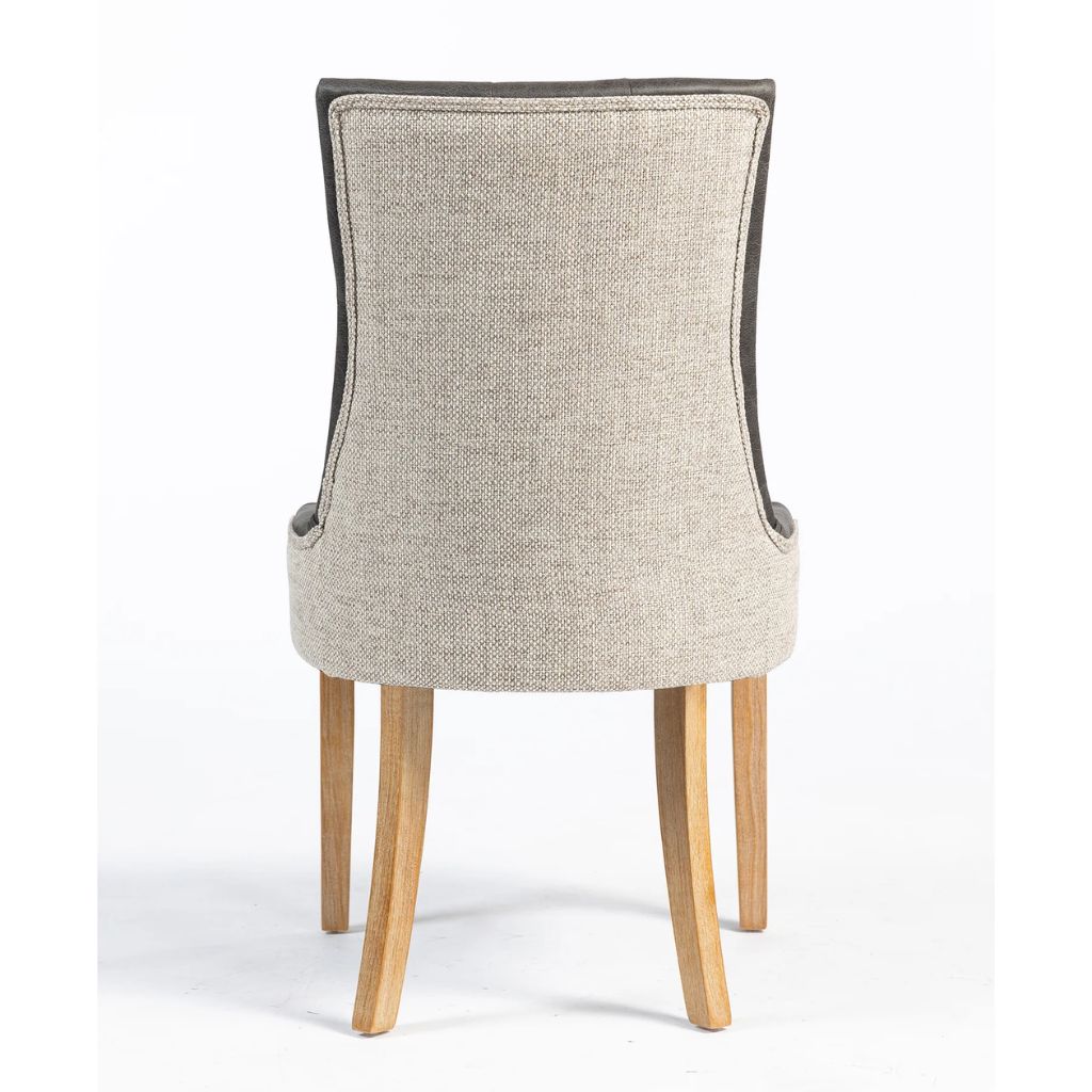 A high-back dining chair with a textured beige fabric back, supported by four light natural wood legs.