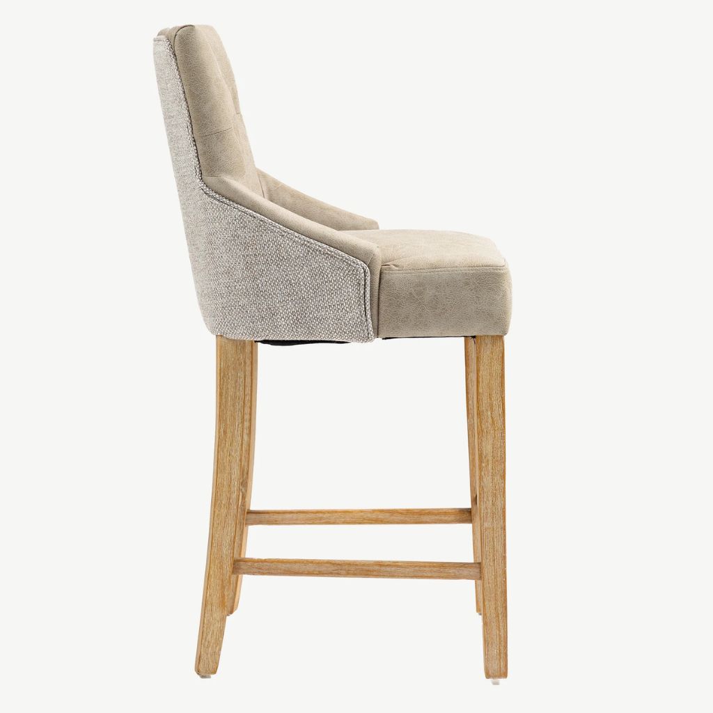 A high-back upholstered bar stool with a textured light beige fabric backrest, supported by four natural wood legs shown from a side profile view.