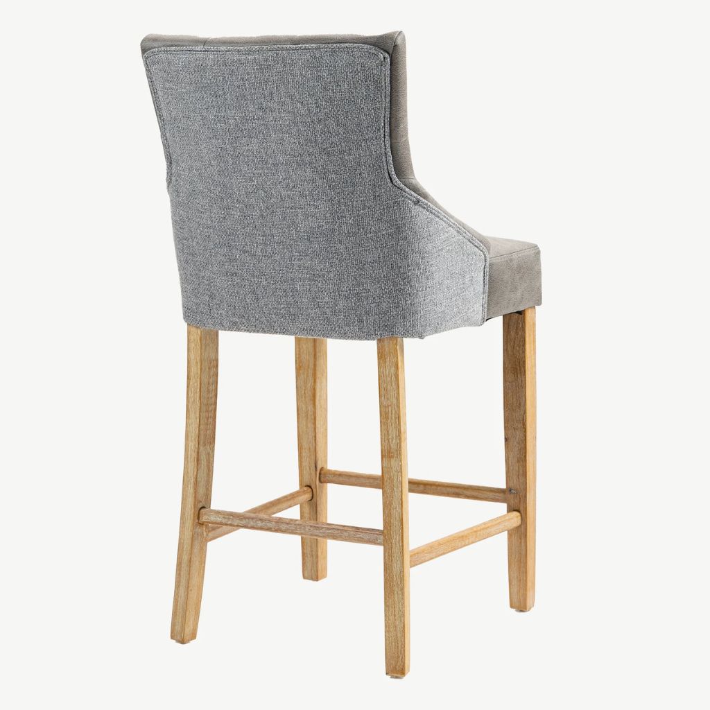 A high-back upholstered bar stool with a textured fabric back, supported by four natural wood legs.