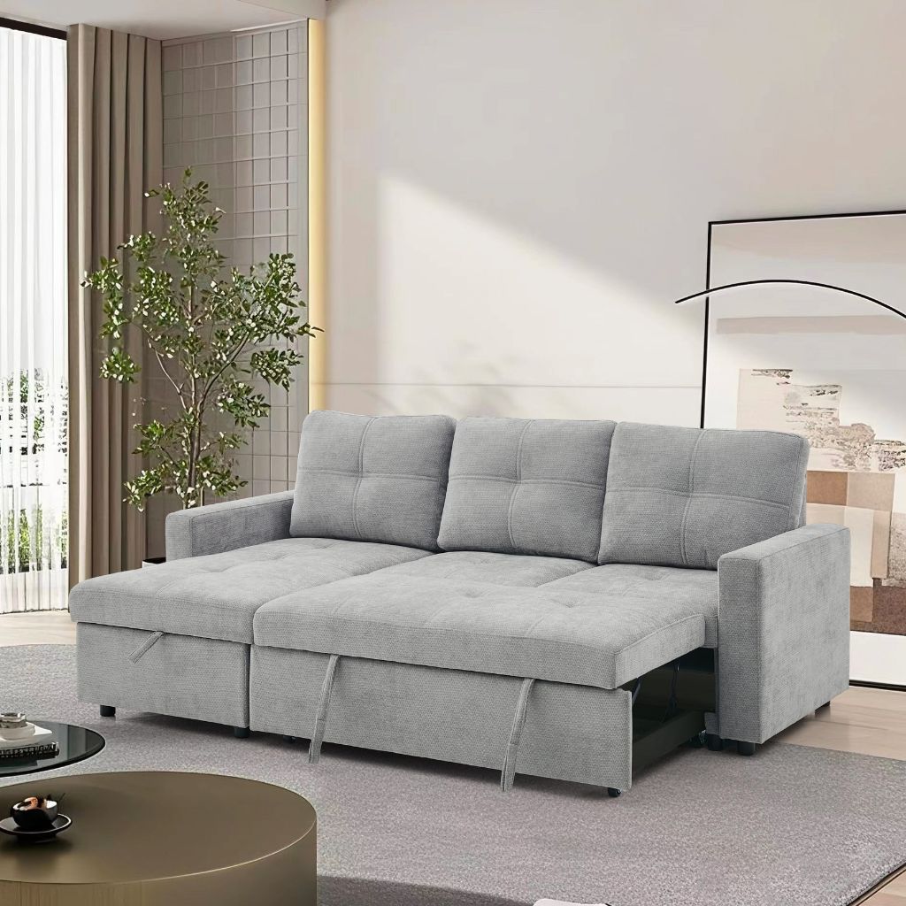 Gray sectional sofa in a modern living room with a plant and coffee table.