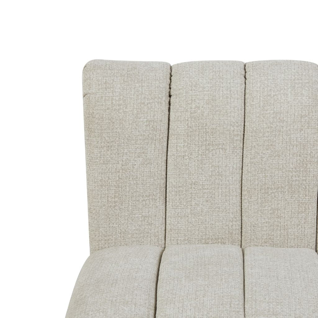 Close-up of fabric upholstered chair or sofa section with vertical channel stitching in colour oatmeal