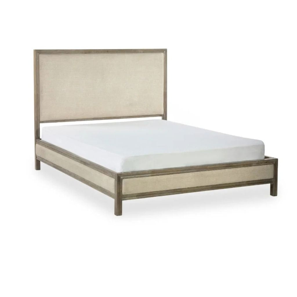 An upholstered bed frame in a warm taupe/beige fabric with a weathered grey-brown wood-look finish. 