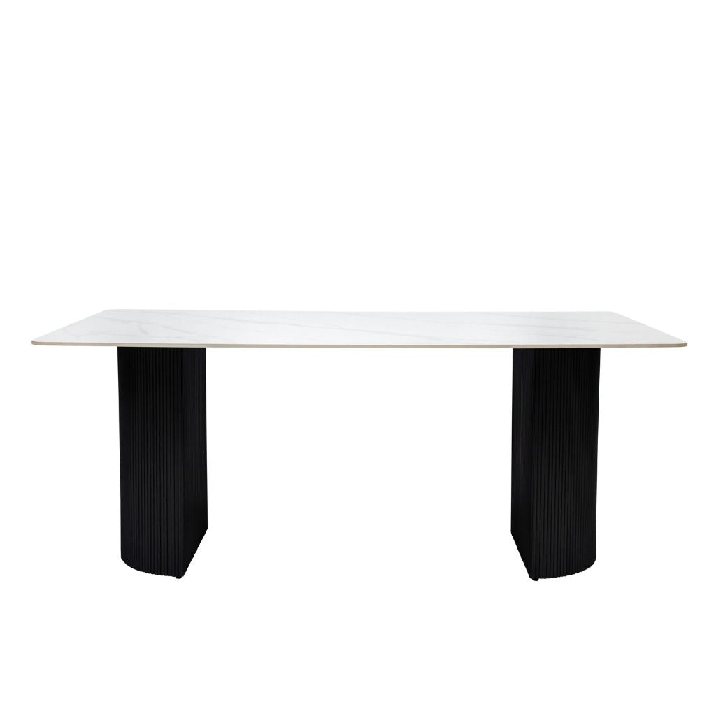 White table with black ribbed legs on a white background
