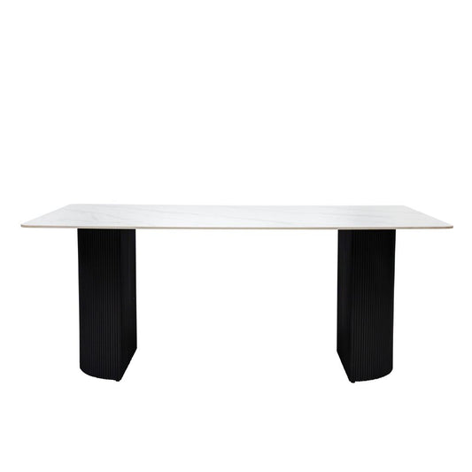White table with black ribbed legs on a white background