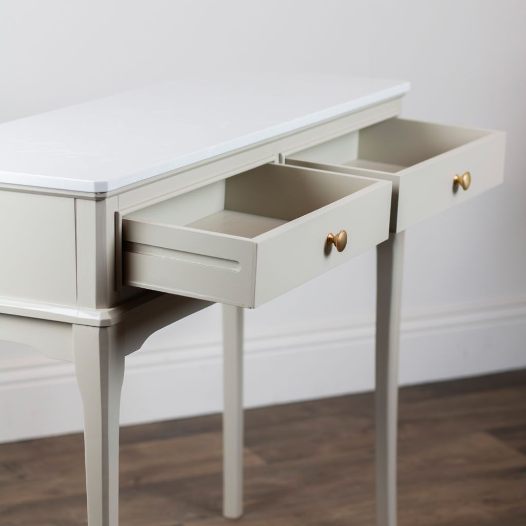 Stone console with open drawers against a white wall