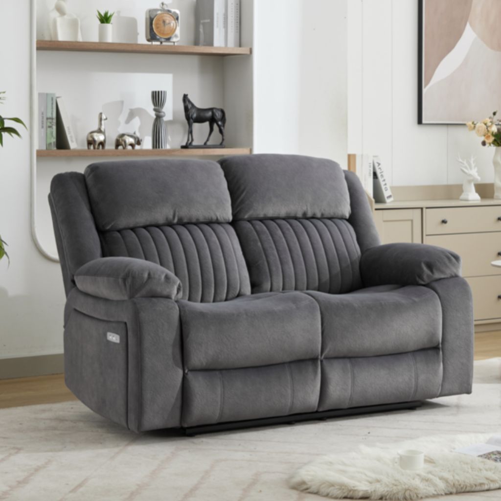 Gray sofa in a living room setting with shelves and decor.
