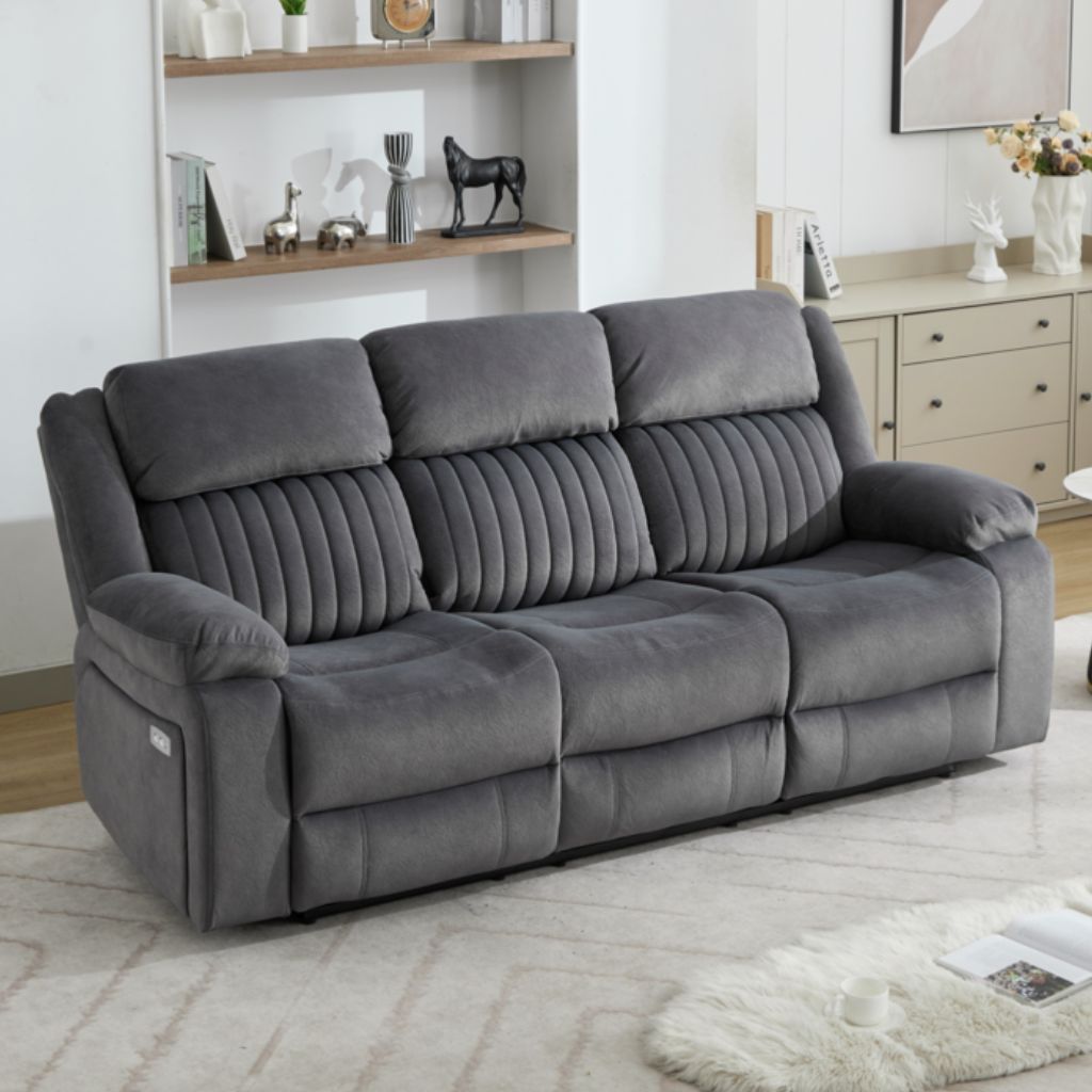 Gray sofa in a living room setting with shelves and decor.