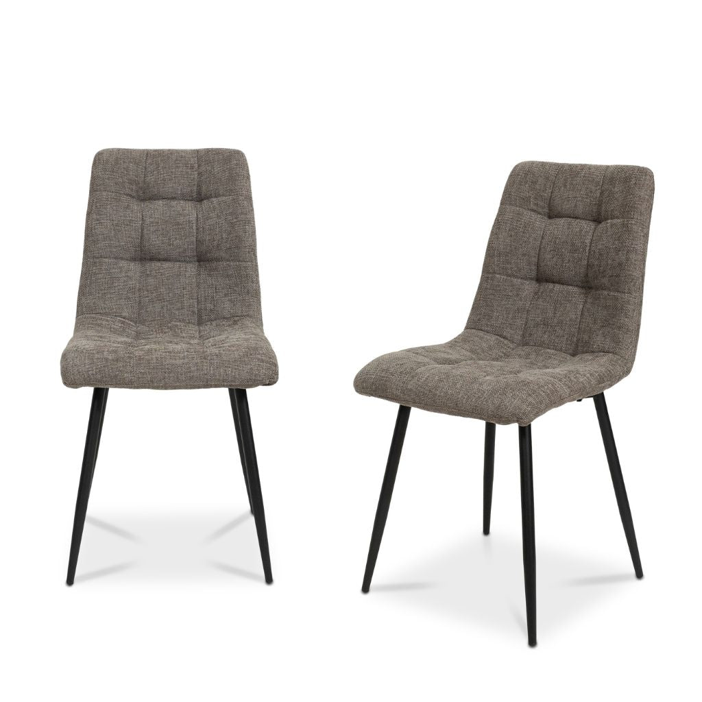 Two beige upholstered chairs with black legs on a white background