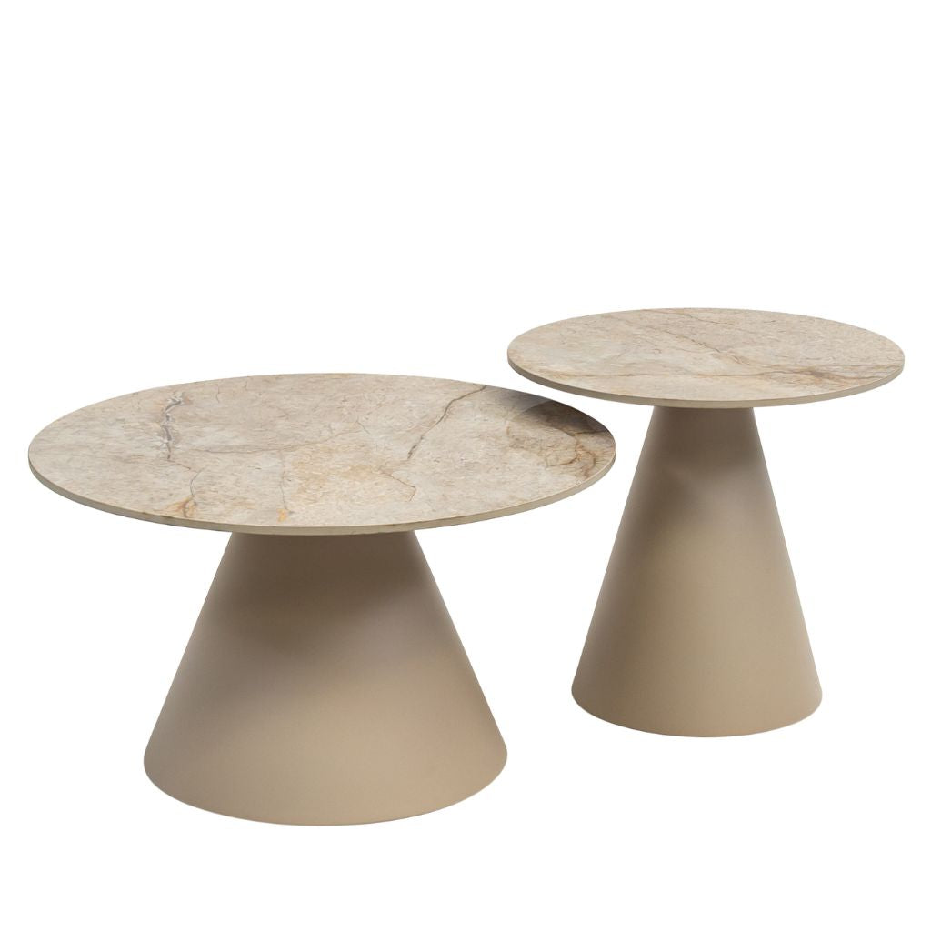 Two modern nesting coffee tables with tapered beige bases and round light beige sintered stone tops.