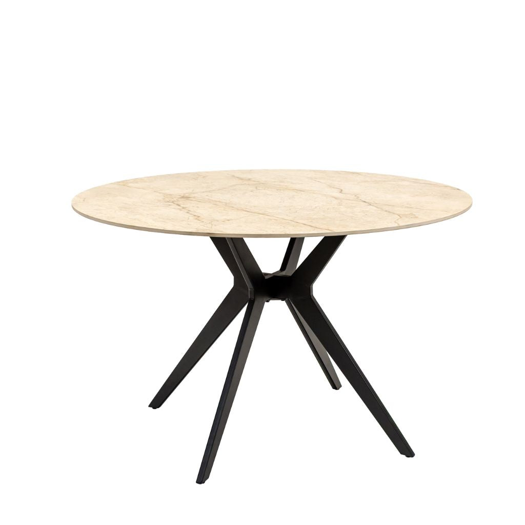 A round dining table with a Shakespeare Taupe sintered stone top and a black metal X-shaped pedestal base. 