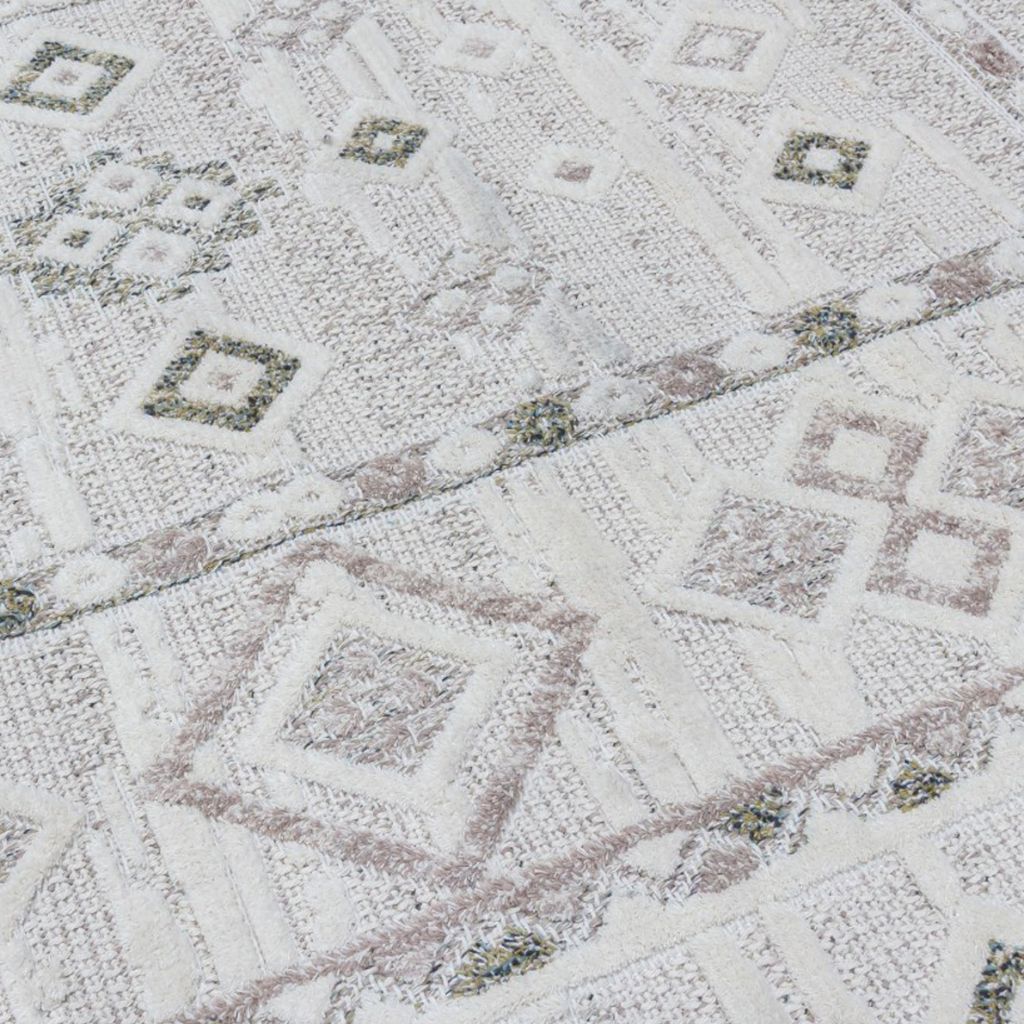 Close-up of a quilt with geometric pattern on a white background
