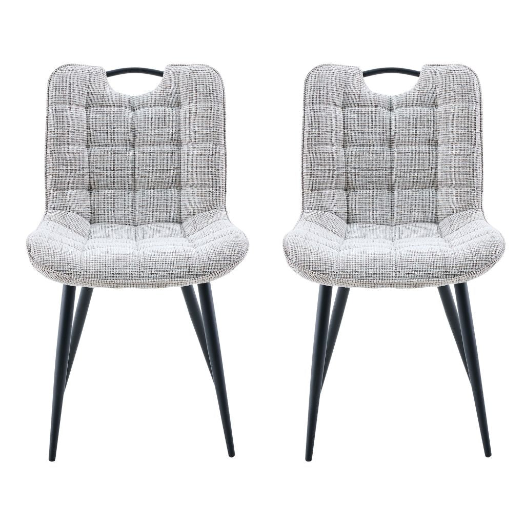 Two biscuit cushioned chairs with black legs on a white background