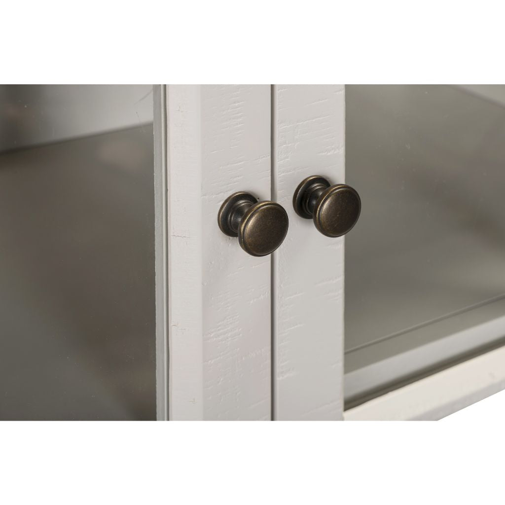 Close-up of a cabinet with bronze handles on a white background