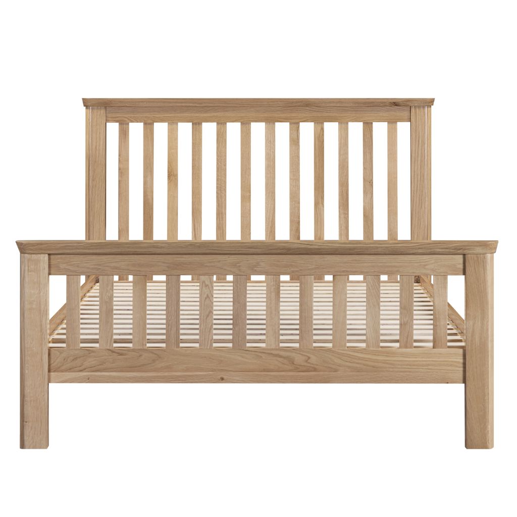 A light natural oak wooden bed frame with a slatted headboard and footboard. 