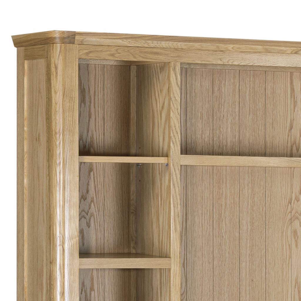 Close-up of a light oak oak media centre with open shelves on the left and panelling detail on the back panel to add a modern flare