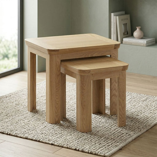 A pair of nested square wooden nesting tables.