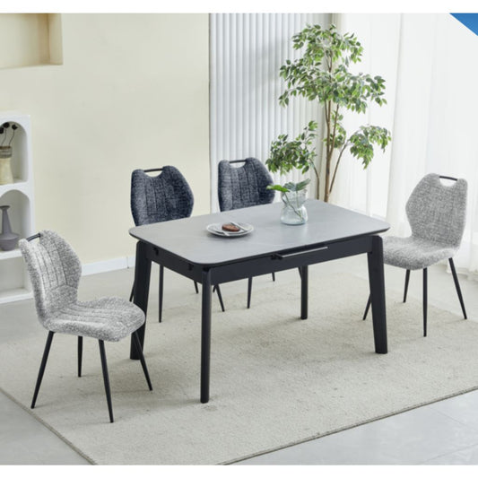 Dining table with four chairs in a modern living room setting