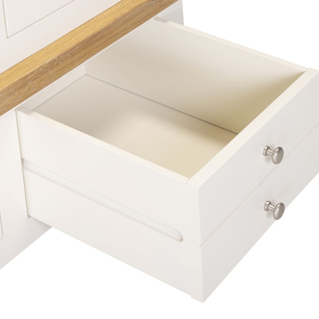 Open ivory drawer with wooden edge on a white background