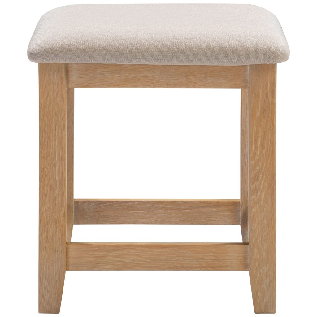 Wooden stool with a beige cushioned seat on a white background