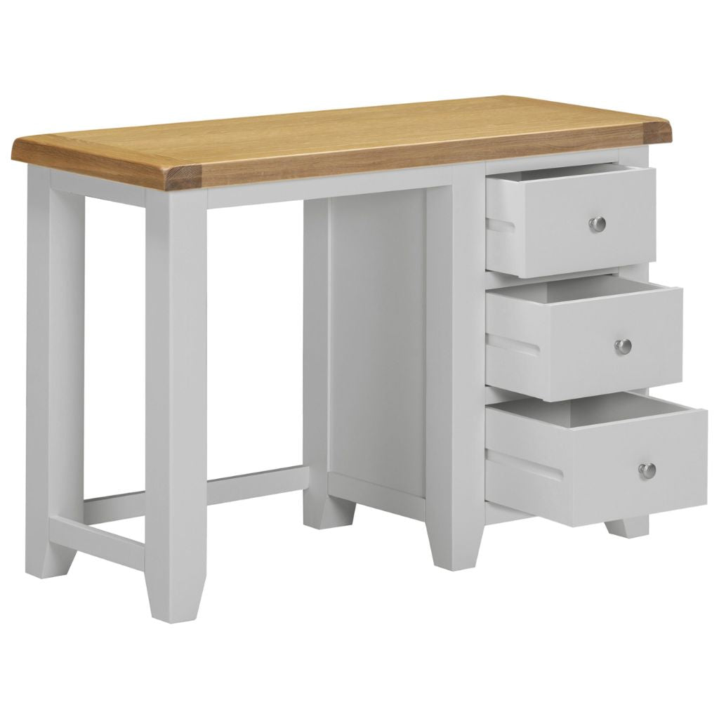 Grey desk with wooden top and three drawers on a white background