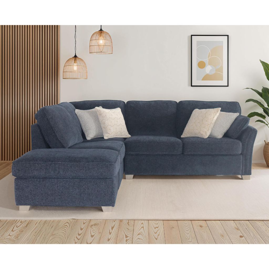 Blue sectional sofa in a living room setting with decor elements.