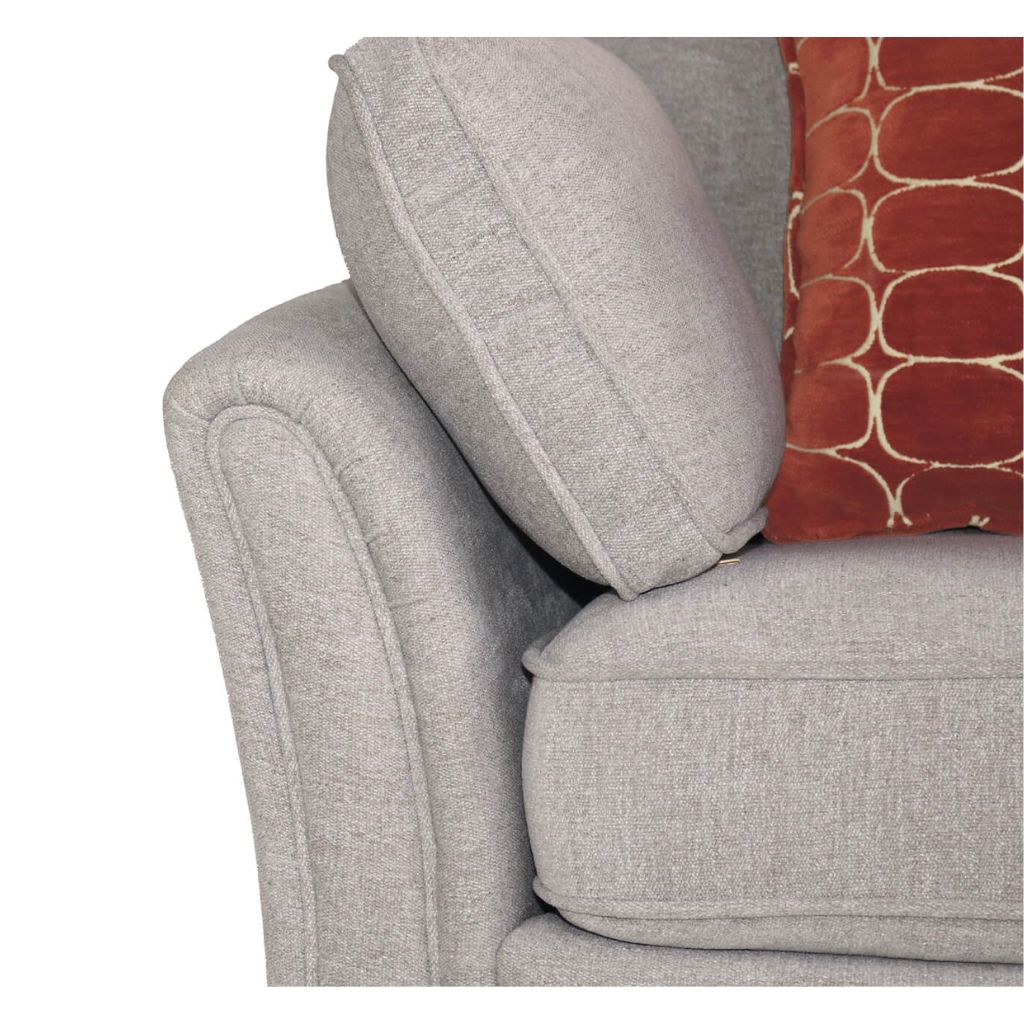 Natural upholstered chair with a red patterned pillow on a white background