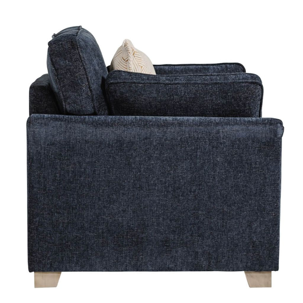 Blue upholstered armchair with a beige pillow on a white background