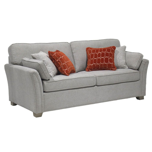 A natural upholstered sofa bed with  orange patterned and natural scatter cushions.