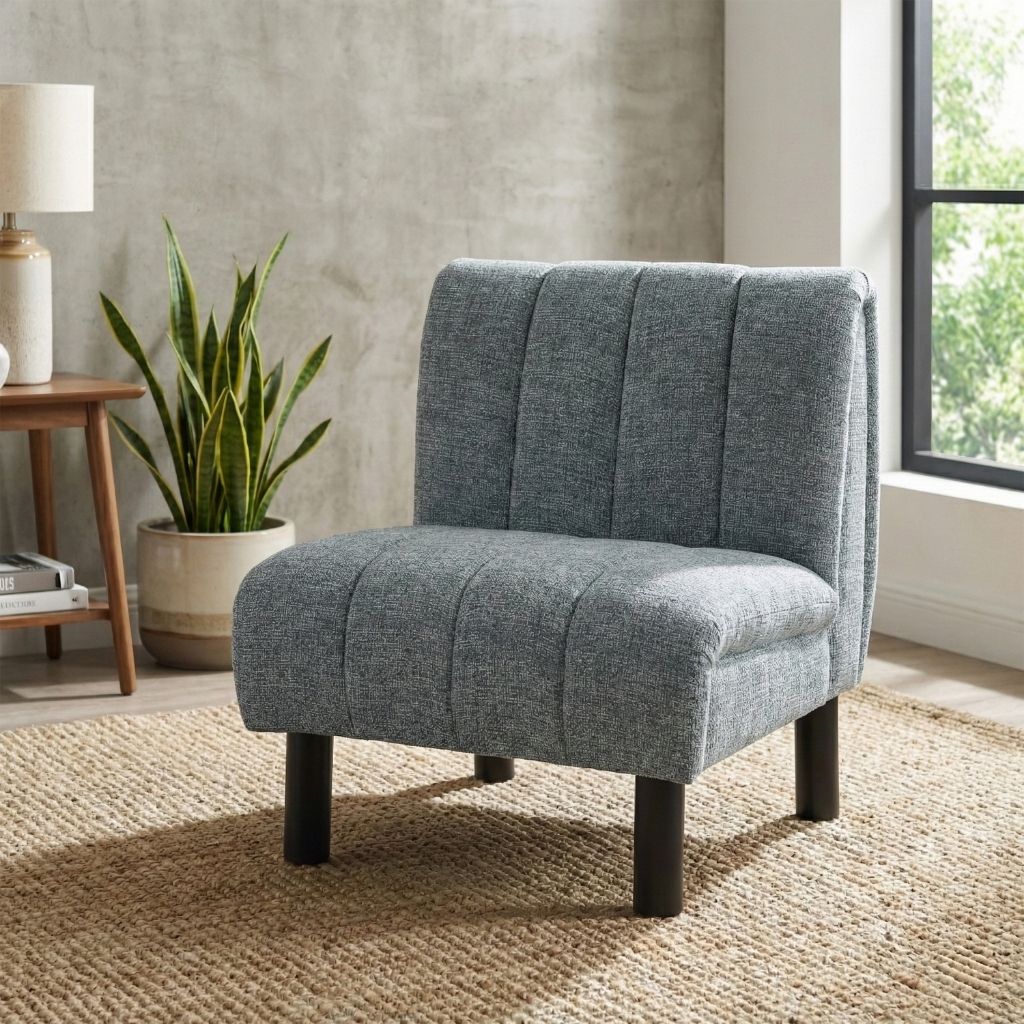 Grey upholstered chair with solid black legs and vertical stitching.