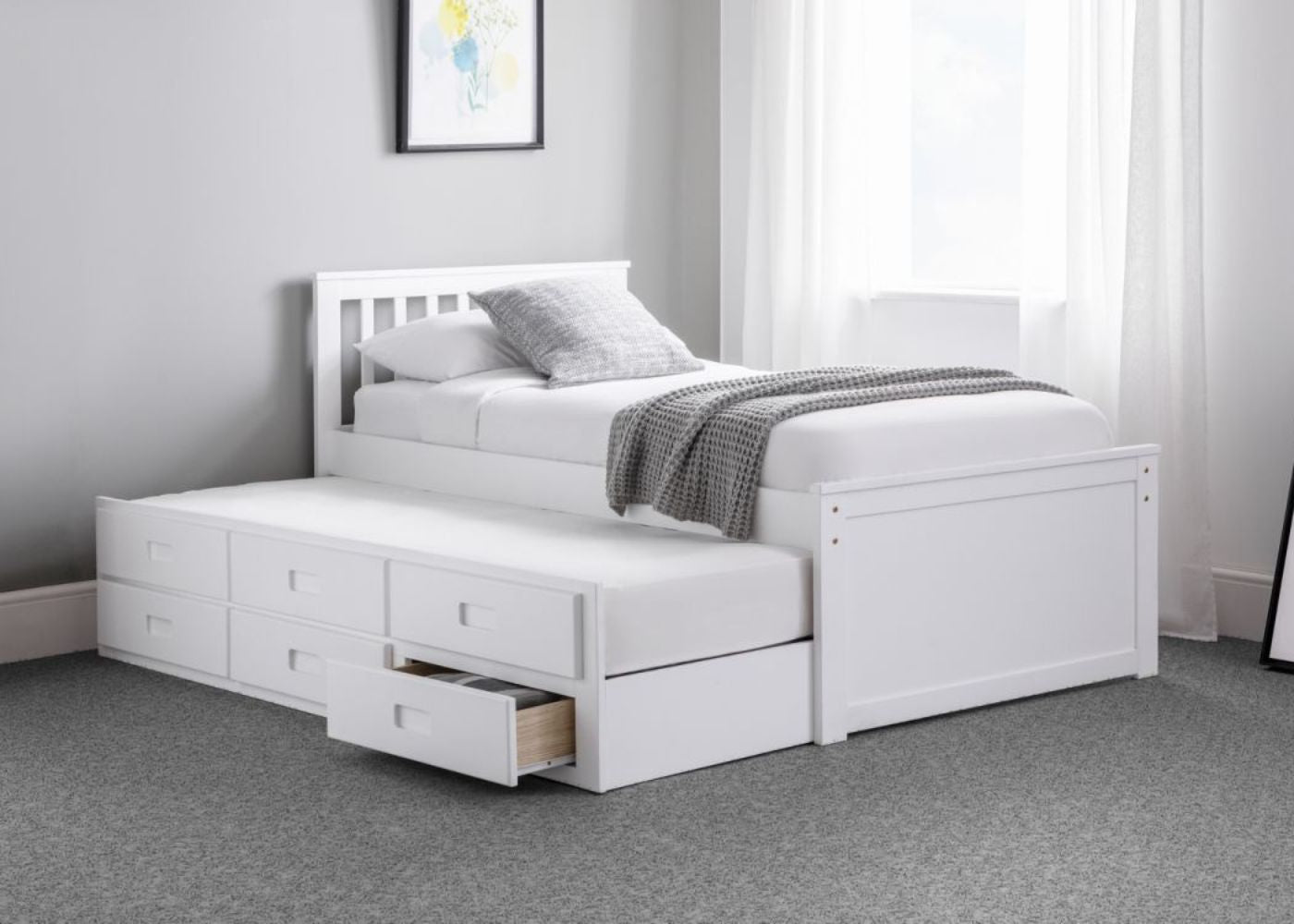 White wooden bed with trundle featuring six drawers