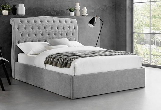 Grey tufted upholstered storage bed.