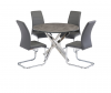 Round grey dining table with four grey chairs and chrome legs.